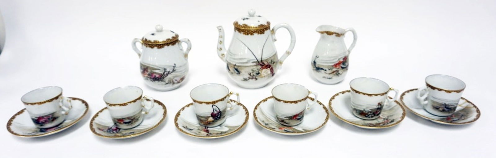 JAPANESE TEASET: JAPANESE TEASET W/HAND PAINTED IMAGES OF LOBSTERS, FISH, ETC, TEAPOT, CREAMER, SUGAR, CUPS & SAUCERS, SOME DAMAGE TO CUPS & SAUCERS