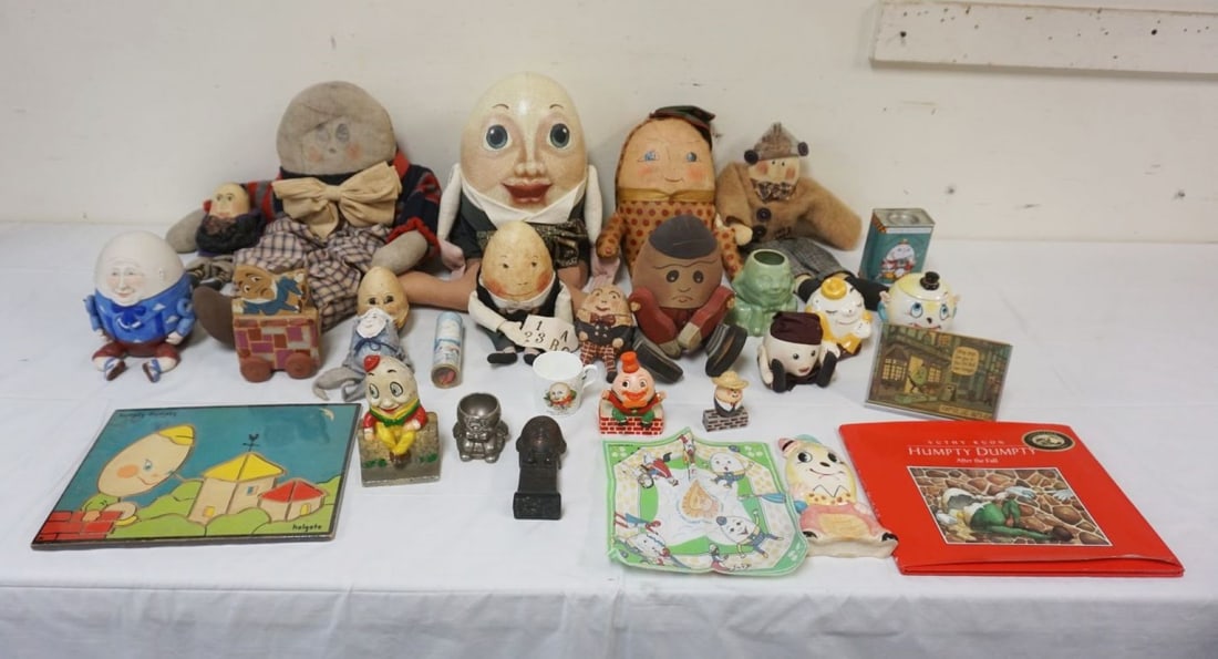 LARGE GROUP OF ASSORTED HUMPTY DUMPTY ITEMS: LARGE GROUP OF ASSORTED HUMPTY DUMPTY ITEMS INCLUDING DOLLS, COVERED JARS, METAL FIGURES, BOOKS, PUZZLES, CAST IRON BANK