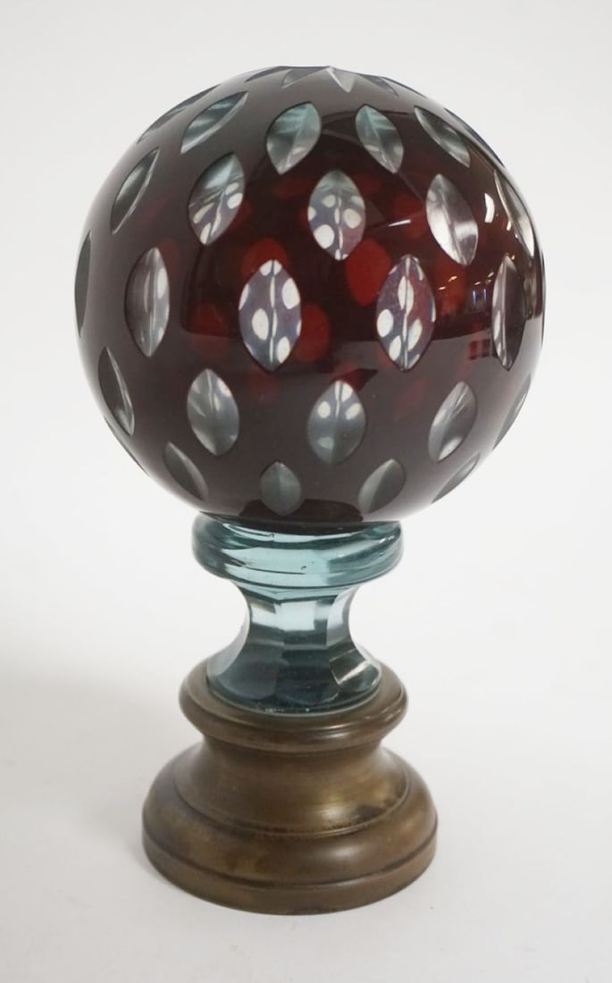 RUBY GLASS CUT TO CLEAR SPHERE PAPERWEIGHT: RUBY GLASS CUT TO CLEAR SPHERE PAPERWEIGHT MOUNTED ON BRASS BASE