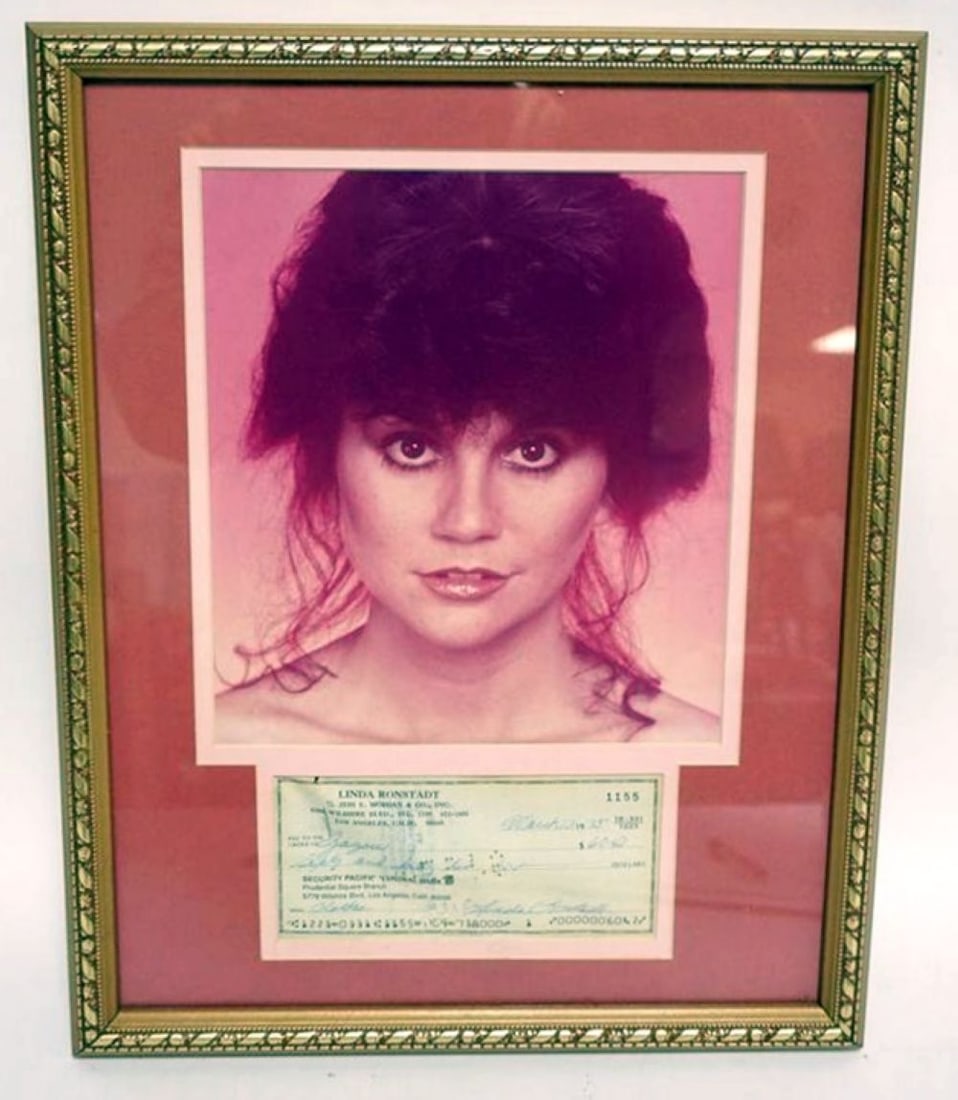 LINDA RONSTADT FRAMED PHOTO & CANCELLED CHECK: LINDA RONSTADT FRAMED & MATTED PHOTO & CANCELLED CHECK W/ATTRIBUTED SIGNATURE, APPROXIMATELY 12 IN X 15 IN OVERALL