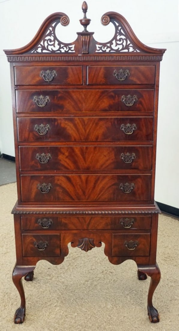 VAN LEIGH FURNITURE HIGHBOY: VAN LEIGH FURNITURE MAHOAGNAY HIGH BOY ON BALL & CLAW CABRIOLE LEGS, FLAMED BOOK MATCHED VENEER DRAWER FRONTS AND PIERCED FRETWORK TOP. APPROXIMATELY 34 IN X 20 IN X 74 IN H