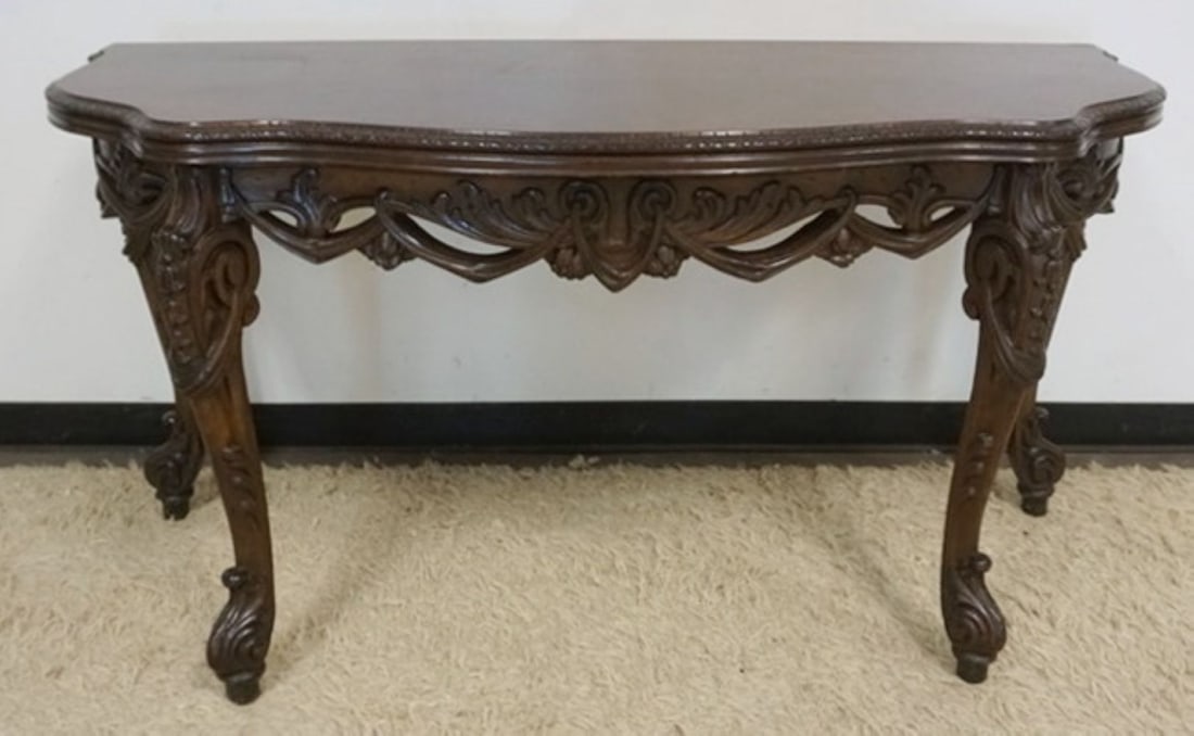 ORNATE CARVED FLIP TOP TABLE: ORNATE CARVED FLIP TOP WALNUT TABLE WITH PIERCED CARVED UNDER CARRIAGE, CLOSED APPROXIMATELY 60 IN X 24 IN X 32 IN H, OPEN 48 IN DEEP