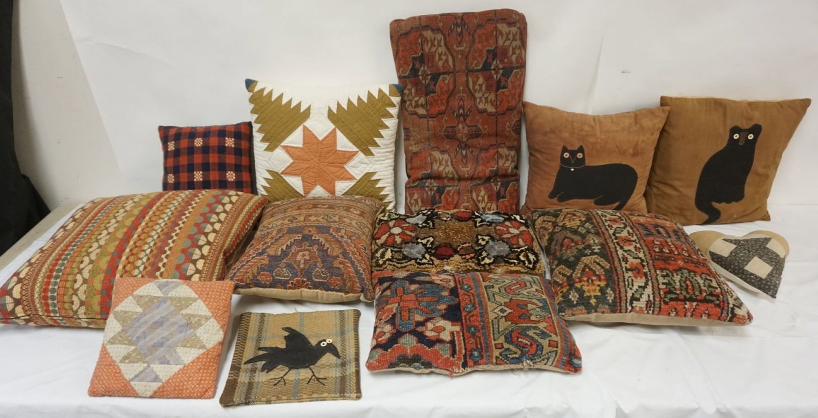GROUP OF VINTAGE CARPET & HAND SEWN PILLOWS: GROUP OF VINTAGE CARPET & HAND SEWN PILLOWS, LARGEST APPROXIMATELY 23 IN X 12 IN