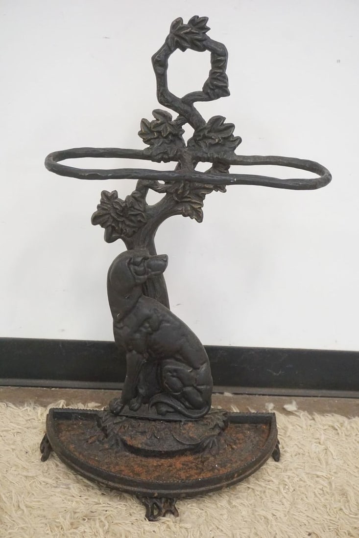 ORNATE CAST IRON DOG UMBRELLA STAND: ORNATE CAST IRON DOG UMBRELLA STAND W/FLORAL VINE DESIGN TOP, APPROXIMATELY 29 IN X 16 IN X 9 IN
