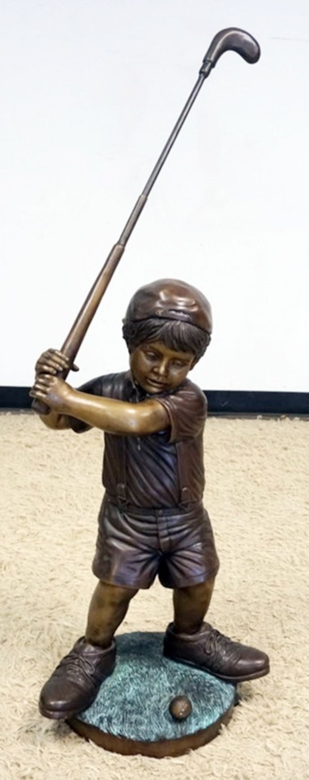 BRONZE STATUE OF YOUNG BOY GOLFING ARTIST SIGNED: LARGE BRONZE STATUE OF YOUNG BOY GOLFING, ARTIST SIGNED ON BACK, APPROXIMATELY 49 IN H, 37 IN WHEN CLUB TOP REMOVED