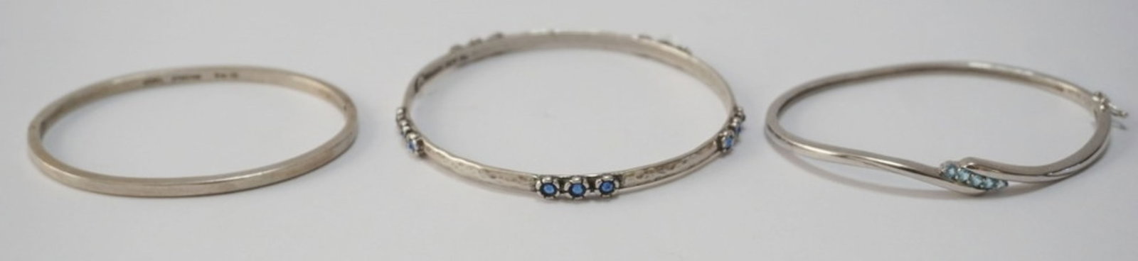 STERLING SILVER BANGLE BRACELETS: 3 BANGLE BRACELETS, 1 MARKED JSN STERLING, 1 MARKED CHINA STERLYIN AND 1 MARKED ISRAEL STERLING, 2 WITH BLUE STONES, 1.14 OZT WITH STONES