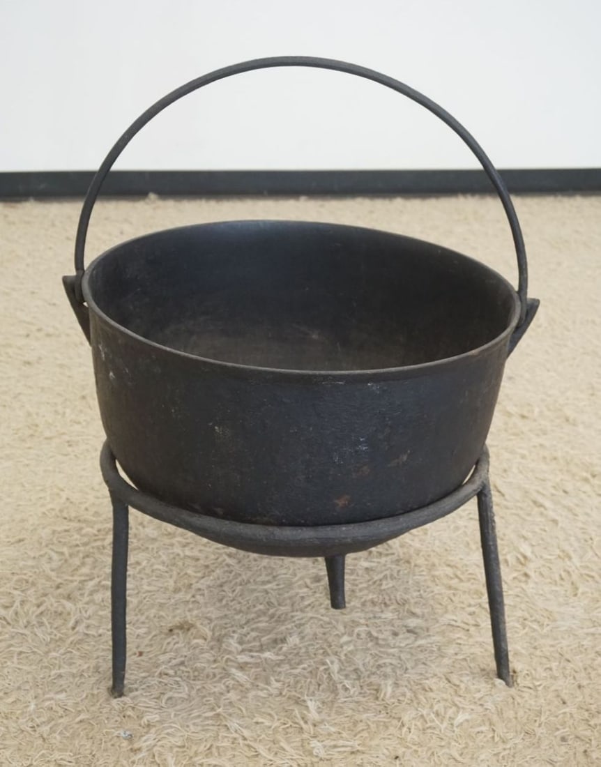 LARGE CAST IRON CAULDRON: LARGE CAST IRON CAULDRON ON IRON STAND, APPROXIMATELY 22 IN X 14 IN HIGH