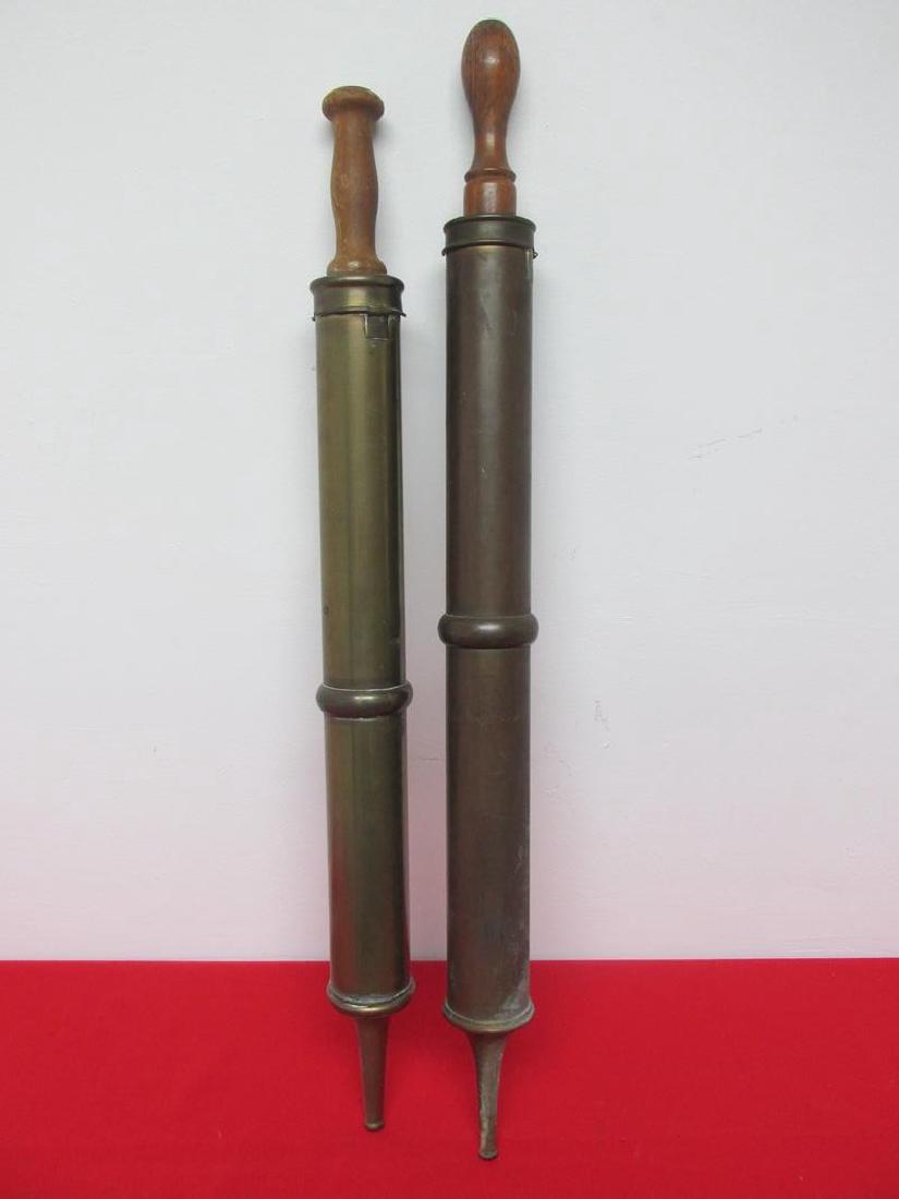 PAIR OF BRASS SQUIRT NOZZLES WITH TURNED HANDLES: LENGTH IS 31"