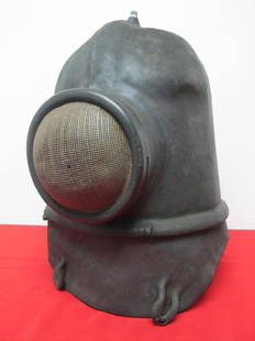 RARE 19TH CENTURY SMOKE HELMET: NATURAL RUBBER COVERING OVER METAL MESH WITH SUPPLIED AIR, GLASS FACE PLATE AND RADIANT HEAT SCREEN. HAS SEEN ACTION WITH SOME MELTING OF THE OUTER RUBBER COVERING EVIDENT ON THE BACK OF HELMEt