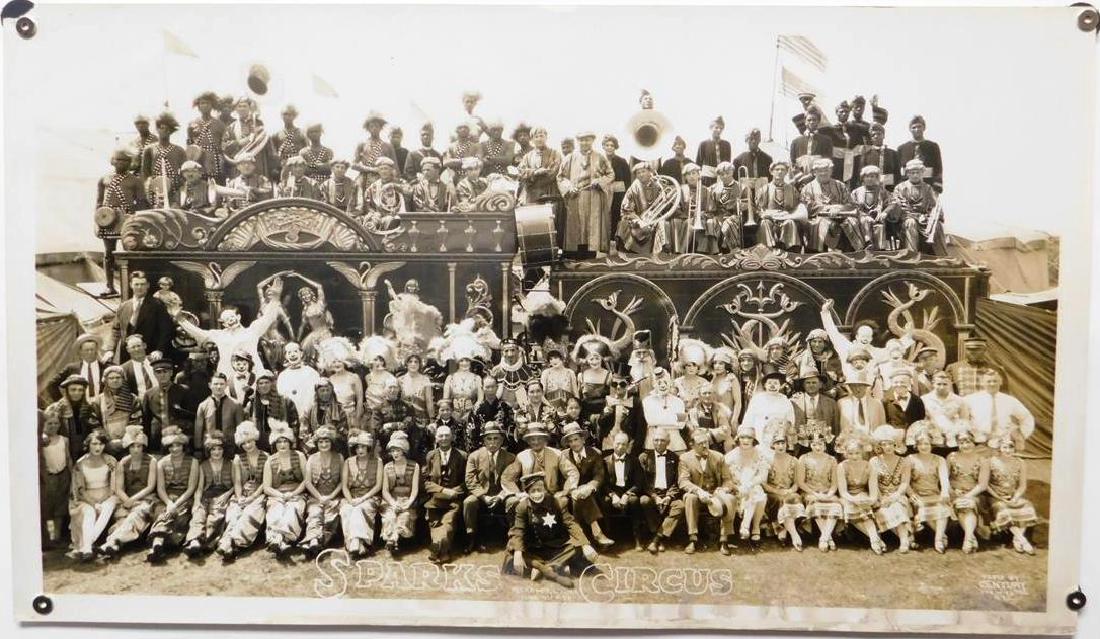 EDWARD J. KELTY (AMERICAN, 1888-1967) PHOTOGRAPH: LARGE FORMAT, ORIGINAL KELTY PHOTOGRAPH DEPICTING SPARKS CIRCUS, JUNE 8TH, 1928, CIRCUS STAFF AND PERFORMERS IN FRONT OF BANDWAGON. TRIPLE RUBBER/INK STAMP ON VERSO. SOME WATER STAINING ON LOWER MARGI