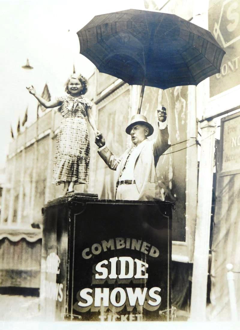 H.A. ATWELL (AMERICAN, 1879-1957) PHOTOGRAPH: SIDESHOW, FEATURING DAISY DOLL ON BALLY BOX. H.A. ATWELL RUBBER/INK STAMP ON VERSO. EXCELLENT CONDITION. 10"X12"