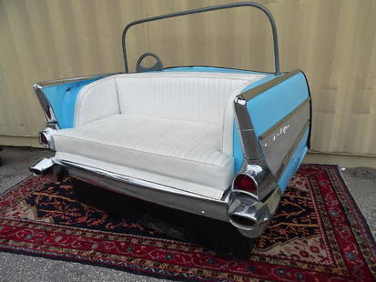 1957 CHEVROLET BELAIR SOFA: FORMERLY USED ON TRAVING SHOW. MOUNTED ON WHEELS. RIGHT SIDE OF BODY HAS BEEN BENT AND MAY REQUIRE SOME ASTHETIC REPAIR.