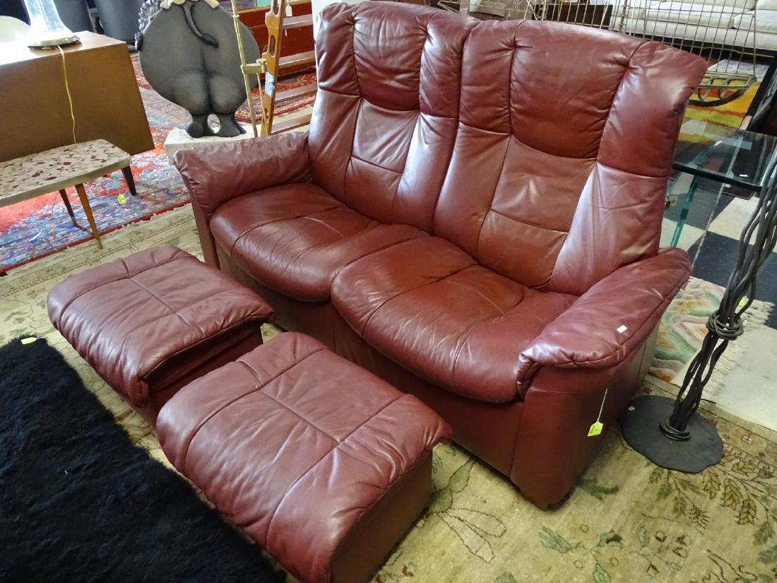 STRESSLESS LOVE SEAT WITH OTTOMANS: RECLINING. CRANBERRY LEATHER. 64"W, 28"D, 15"SEAT, 39"BACK.