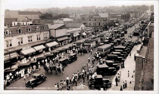 EDWARD J. KELTY (AMERICAN, 1888-1967) PHOTOGRAPH: LARGE FORMAT, ORIGINAL KELTY PHOTOGRAPH DEPICTING DOWNIE BROS. CIRCUS STREET PARADE, ENGLEWOOD, NEW JERSEY, AUGUST 14TH, 1931. DOUBLE RUBBER INK STAMP ON VERSO. 12"X20"