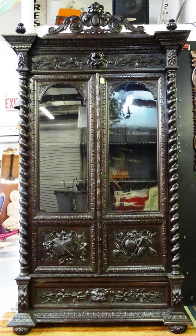 19TH C. FRENCH HUNTING CABINET - BOOKCASE: BLACK FOREST, HEAVILY CARVED WITH GOTHIC MOTIF. HAVING INTERIOR SHELVING AND LOWER DRAWER.