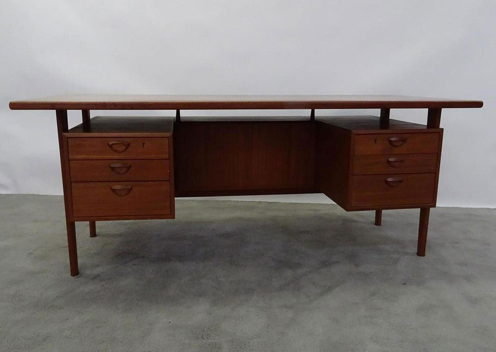 KAI KRISTIANSEN EXECUTIVE FLOATING TOP TEAK DESK: DOES HAVE MATERIAL MISSING FROM ONE OF THE CUPPED DRAWER PULLS.
