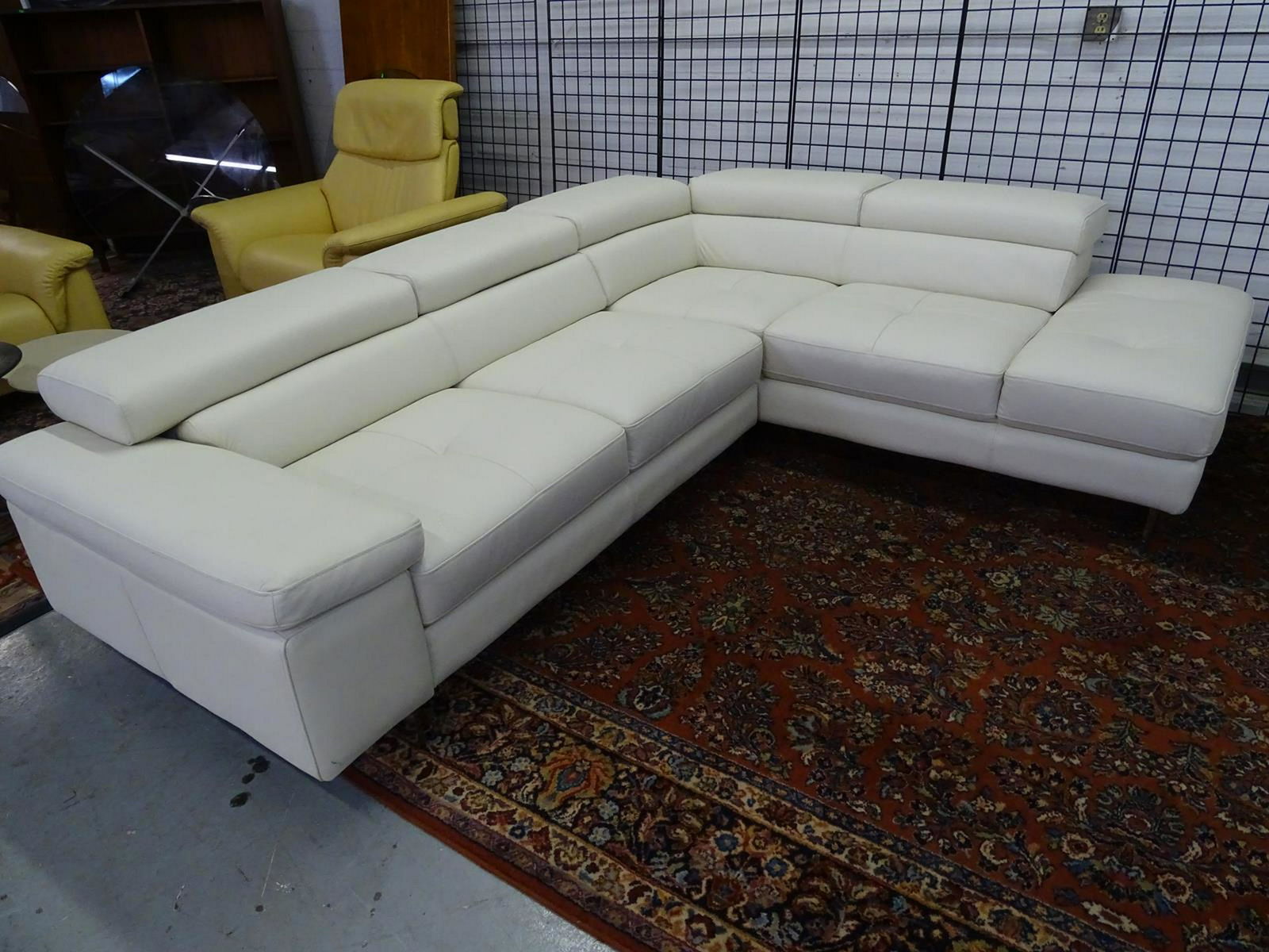 ITALIAN WHITE LEATHER SECTIONAL SOFA: HAVING LIFT HEAD RESTS AND CHROME ACCENTS