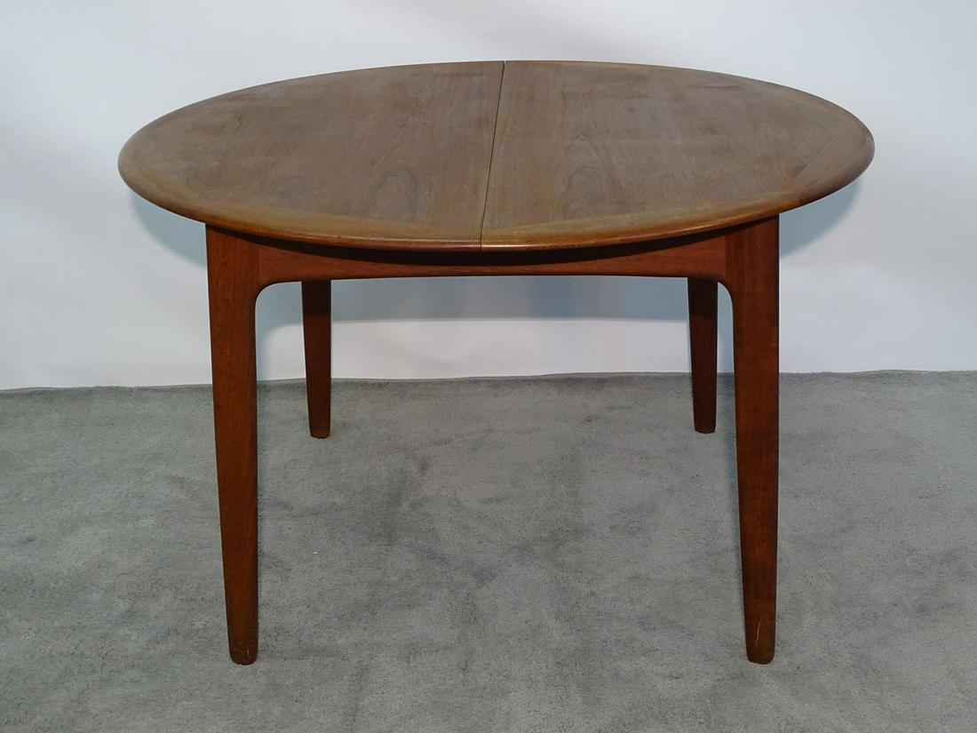SVEND AAGE MADSEN TEAK DINING TABLE: HAVING A PAIR OF HIDDEN LEAVES, SIGNED.