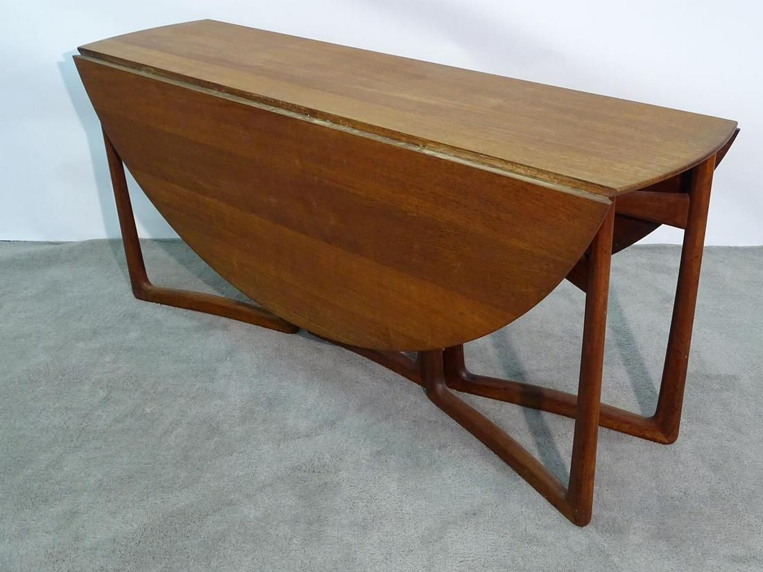 PETER HVIDT/ORLA MOLGAARD SCULPTURAL TABLE: TEAK, HAVING SWING LEGS WITH DROP LEAVES. JOHN STUART LABEL. TOP IS 56"X64"X28"H