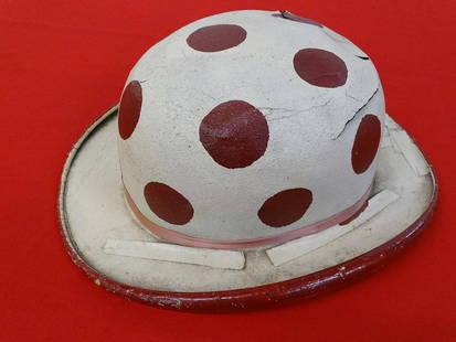 JACK LECLAIR (1890-1971) CLOWN HAT: JACK LECLAIR WAS A CLOWN ON THE RBBB CIRCUS FOR OVER 30 YEARS BEGINNING IN THE LATE 1910'S. TRADEMARK CAP HAS WEAR CONSISTENT WITH AGE INCLUDING TAPE, STIFFNESS AND PUNCTURES.