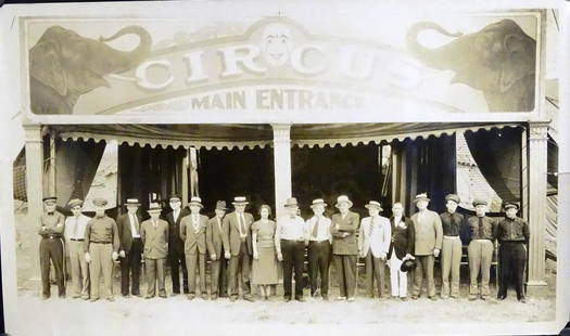 EDWARD J. KELTY (1888-1967) PHOTOGRAPH: ORIGINAL KELTY PHOTOGRAPH OF THE RBBB CIRCUS STAFF AT CIRCUS MAIN ENTRANCE. SAM GUMPERTZ, MANAGER, AT FRONT AND CENTER. STAMP ON VERSO.
