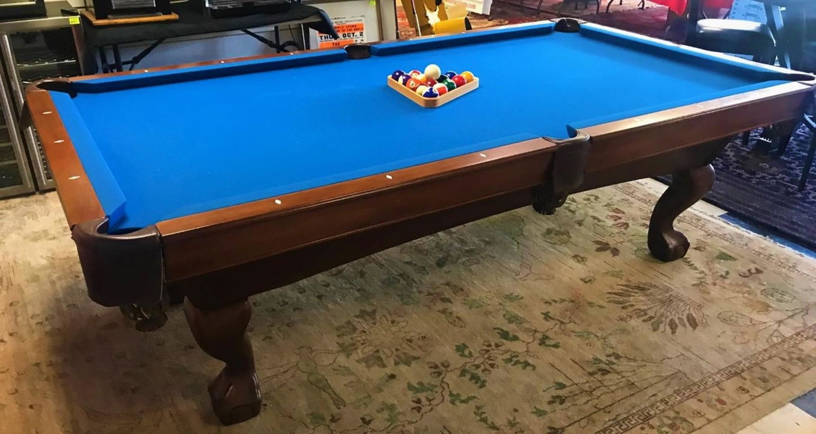 BRUNSWICK TREMONT 8' POOL TABLE: BRUNSWICK 8' TABLE IN CHESTNUT. BLUE FELT IN GOOD CONDITION. A COUPLE OF MINOR FURNITURE FLAWS BUT OVERALL EXCELLENT CONDITION. INCLUDES 4 STICKS, CHEATER, BRUSH, BALLS.