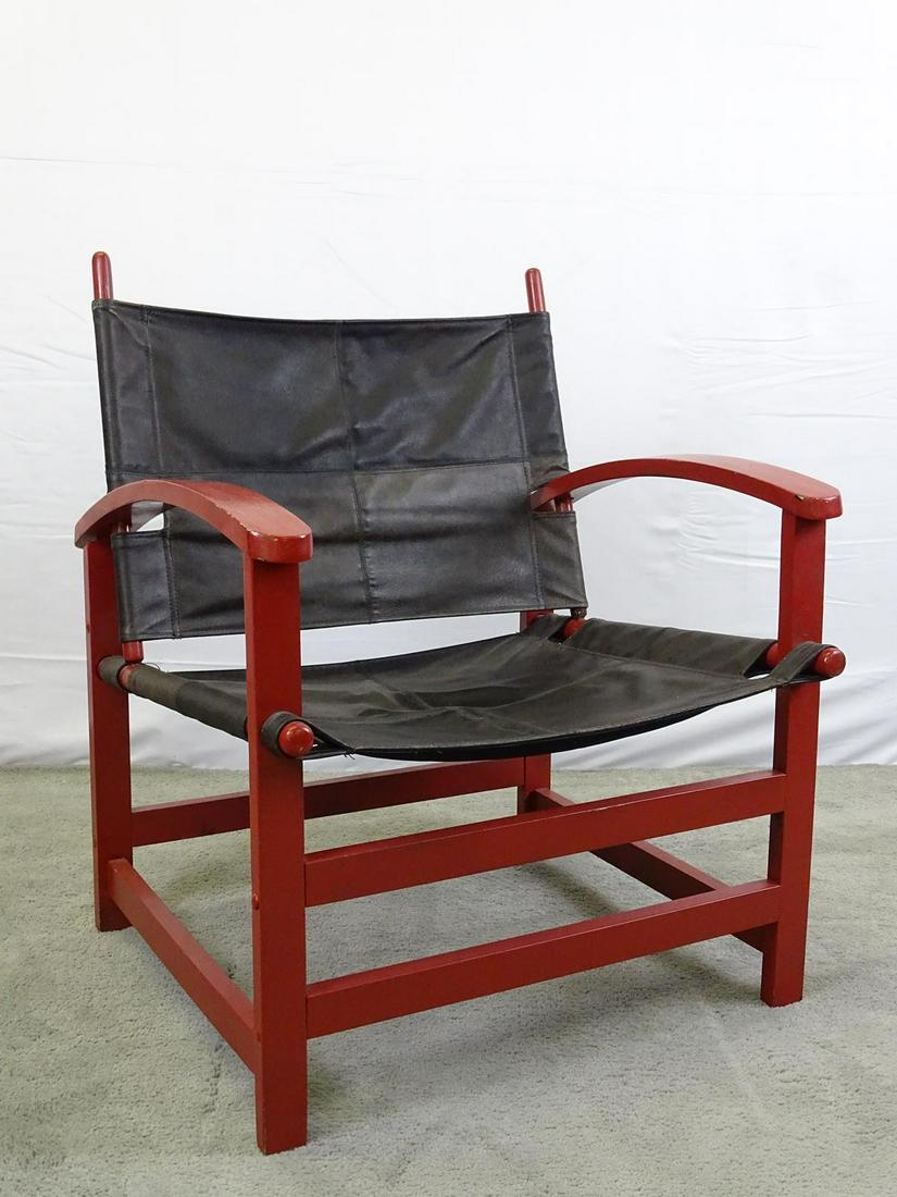 MID-CENTURY LEATHER SLING CHAIR: LEATHER SLING, WOOD FRAME. SOME SEPARATING OF WOODEN ARM AND LOOSE JOINTING OF CHAIR. SOLD AS-IS. 26"X25", 15"SEAT, 32"BACK.