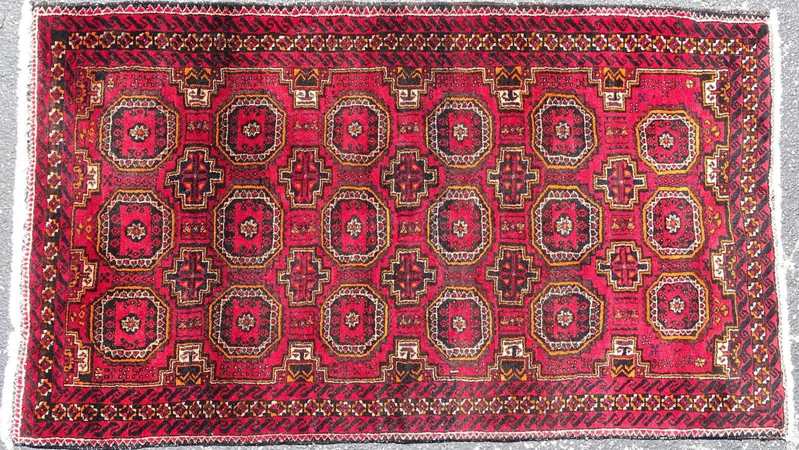 AFGHAN STYLE BOKHARA RUG: DEEP RED WITH INDIGO AND ORANGE ACCENTS, WEAR AT EDGES, GOOD PILE. 42"X75"