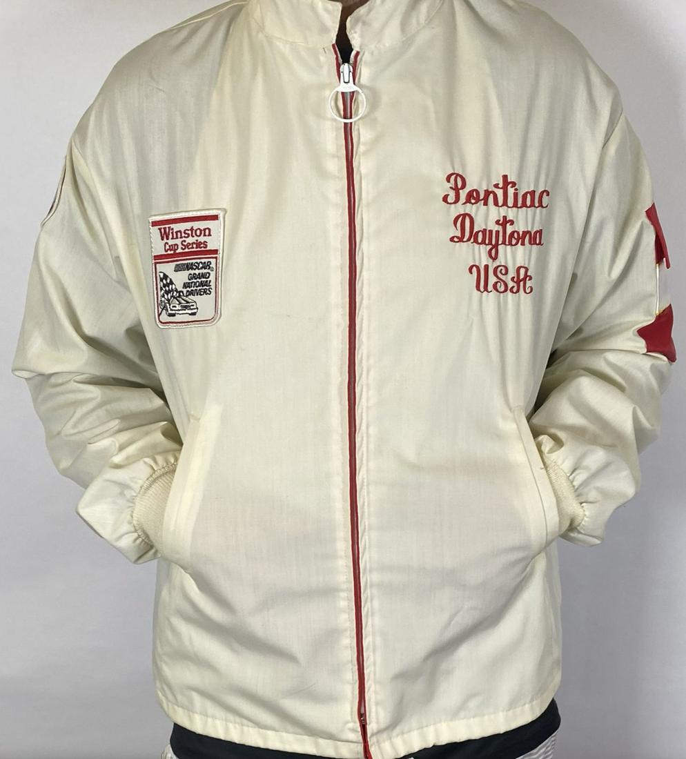 NASCAR - WINSTON CUP - RICHARD PETTY JACKET: VINTAGE PONTIAC DAYTONA USA JACKET BEARING WINSTON CUP AND STP PATCH. HAVING LEFT SLEEVE CIGARETTE POUCH. ADULT LARGE, EXCELLENT CONDITION.