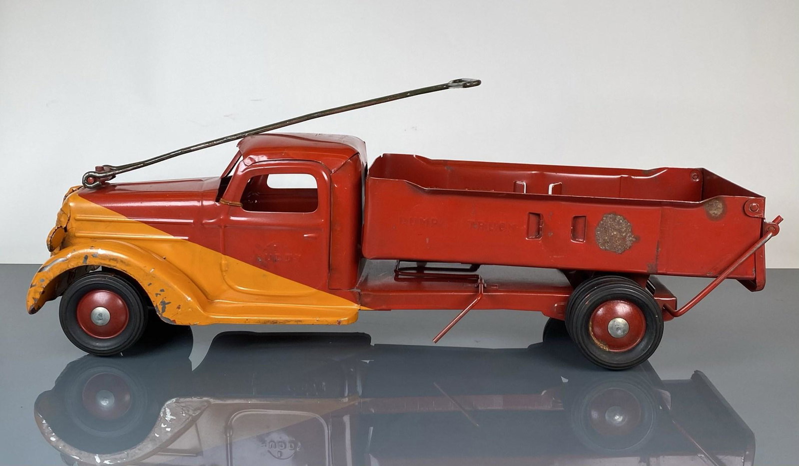 LARGE BUDDY-L PRESSED STEEL DUMP TRUCK: MODEL 702, RIDER (MISSING SEAT) OR PULL. REPAINT. 21"X6"X6"