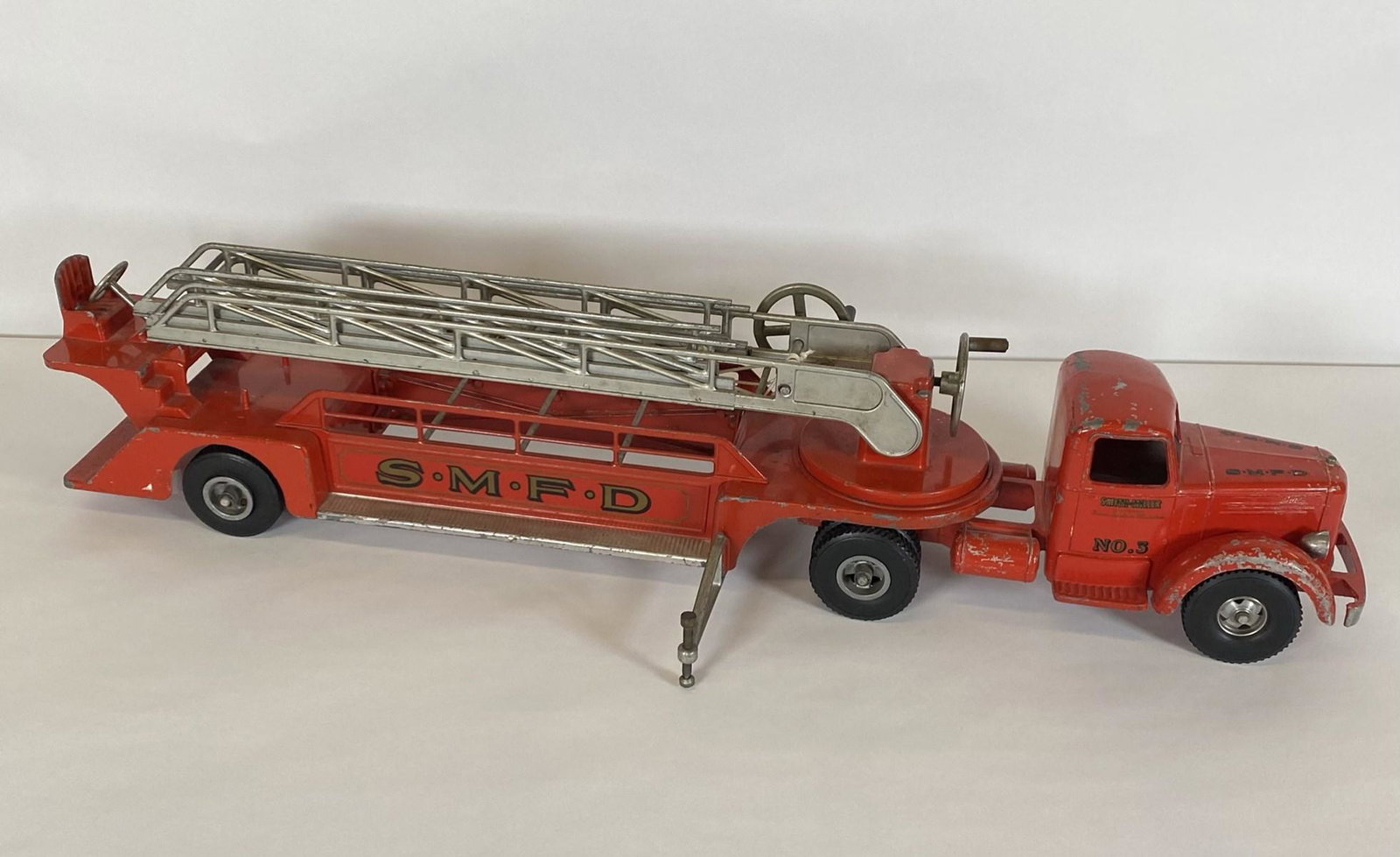 LARGE SMITTY TOYS FIRE LADDER TRUCK: FAMOUS TRUCKS IN MINIATURE", WITH WORKING CRANKS. 35"X6"X7