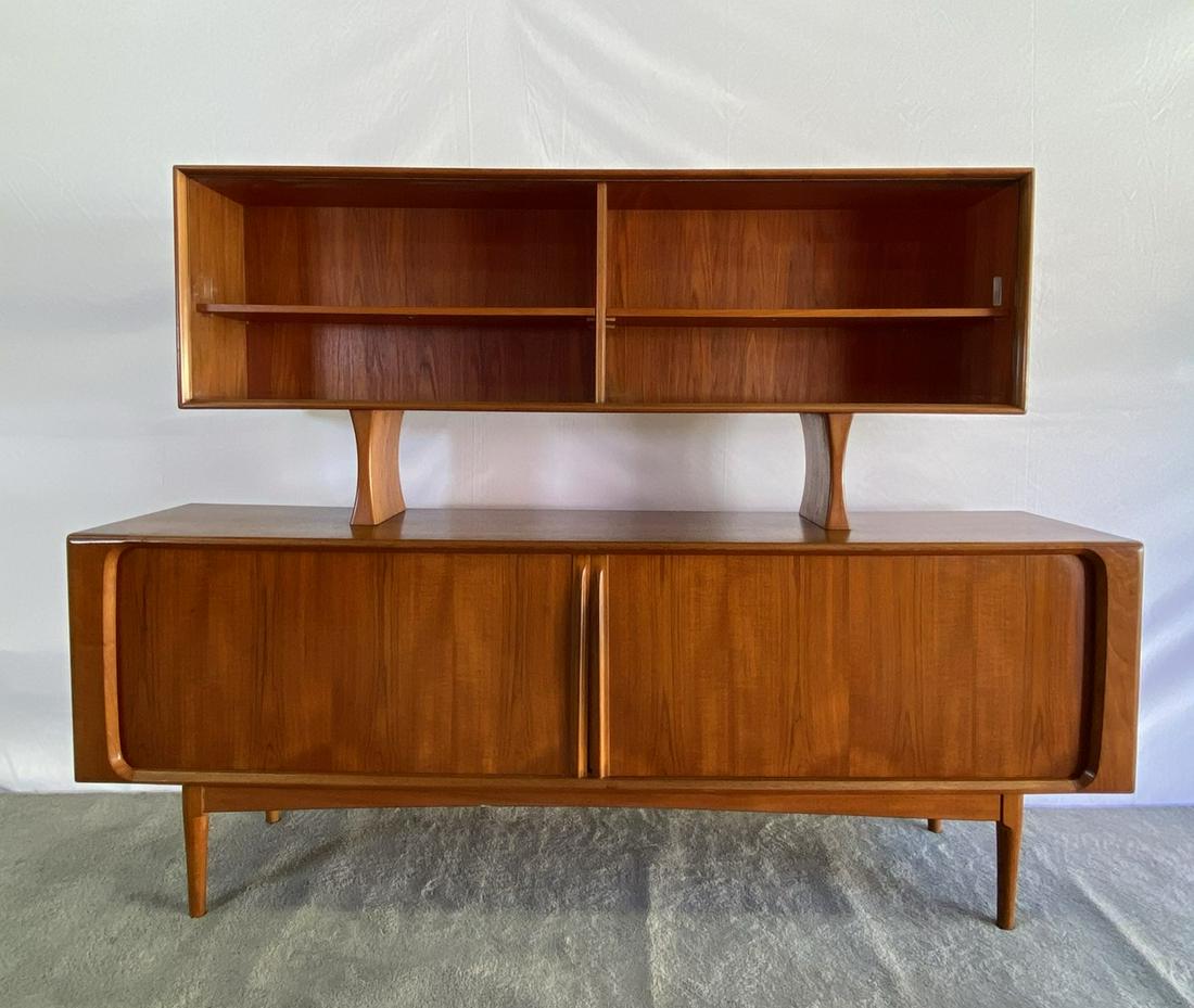 BERNARD PEDERSEN BUFFET CREDENZA: TEAK CABINET WITH GLASS FRONT UPPER CABINET. 83"X19.5"X32" (LOWER). OVERALL HEIGHT IS 62". GOOD CONDITION. ONE MINOR CHIP IN CABINET SIDE AND A 4" SCRATCH TO THE TOP SIDE OF THE UPPER CABINET.