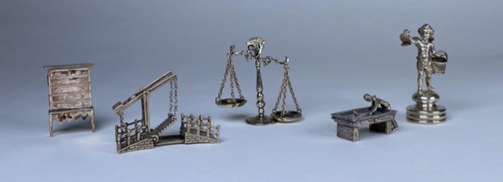 GROUPING OF STERLING SILVER MINIATURES: CHERUB, HIGH-BOY, SCALE, DRAWBRIDGE, BILLIARD. 100 GRAMS TOTAL WEIGHT.