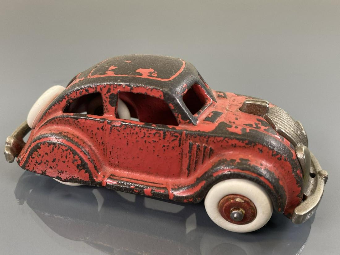 ARCADE AIRFLOW SEDAN: CAST IRON IN ORANGE. ORIGINAL WITH PAINT LOSS. 4"
