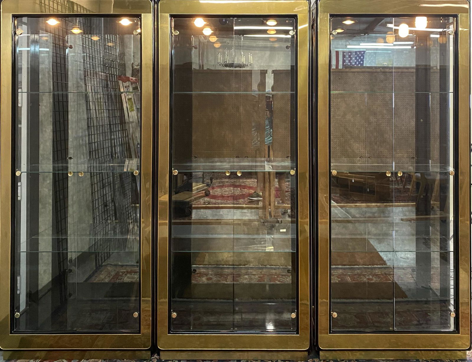 MASTERCRAFT DISPLAY CABINETS: LOT OF 3 CABINETS HAVING EBONIZED BODY WITH BRASS ACCENT TRIM. GLASS SHELF INTERIOR WITH LIGHTS. LABELED. EACH CABINET IS 36"X16"X84"