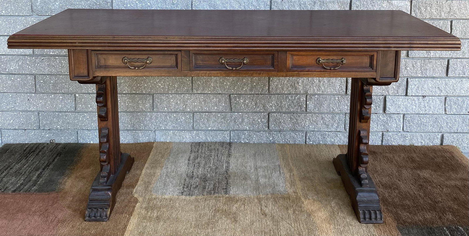 VINTAGE WRITING DESK: HAVING THREE DRAWERS, LEATHER TOP WITH GILT BORDER. WEAR CONSISTENT WITH AGE. 62"X25"X30"