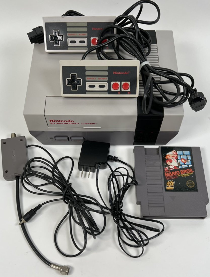 1985 NINTENDO ENTERTAINMENT SYSTEM: INCLUDES CONSOLE, 2 CONTROLLERS, POWER SUPPLY AND SUPER MARIO BROS. GAME. TESTED IN WORKING CONDITION.