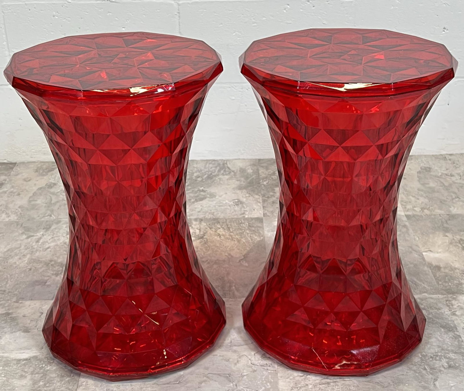 MARCEL WANDERS RED DIAMOND STOOLS: PAIR OF RED TINTED ACRYLIC STOOLS WITH FACETTED DESIGN. 18"H