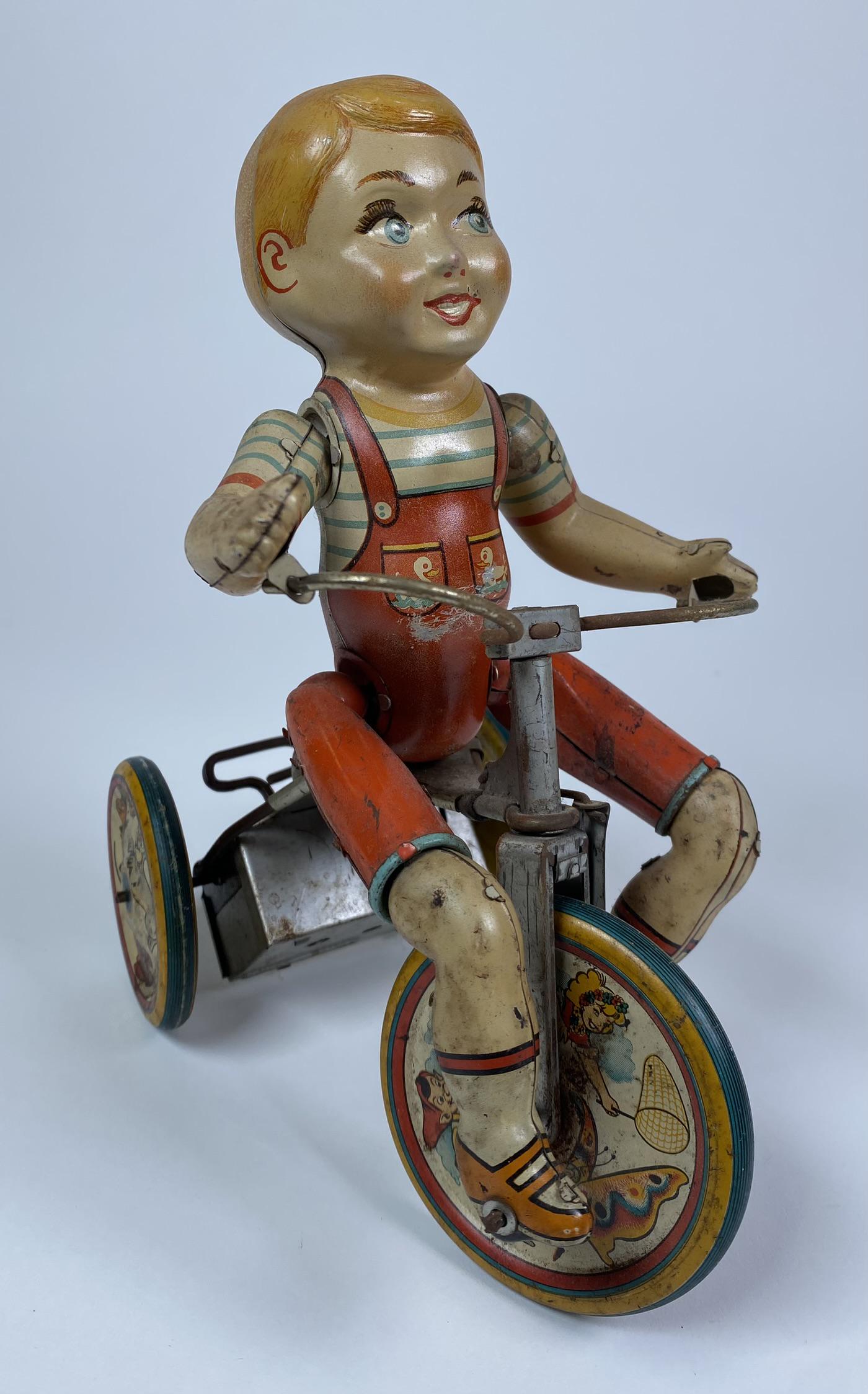 UNIQUE ART KIDDY CYCLIST TIN TOY: KIDDY CYCLIST BY UNIQUE ART C.1950. WINDUP WORKS BUT STICKS. 7.5" LONG