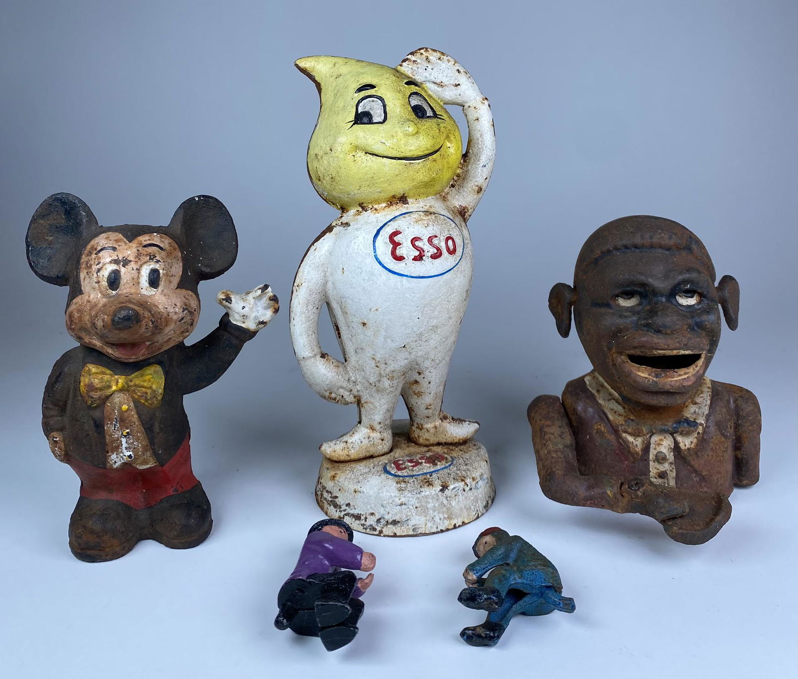 CAST IRON BANKS FIGURES: ESSO, MICKEY, AND JOLLY N PRESENT. BANK AND FIGURES MORE MODERN RECASTINGS. ESSO STANDS 9" TALL