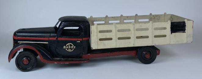 BUDDY L FARM TRUCK: MEDIUM SCALE FARM TRUCK WITH OVERPAINTED PINSTRIPES AND BLACK CAB. NO BUMPER. C.1935. 22" L