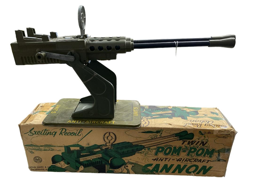 POM-POM TWIN CANNON BY MARX: POM-POM TWIN CANNON BY MARX. GREAT TOY WITH SITES AND TIN LITHO BASE. WORKS WITH A LOUD POPPING NOISE. BOX IN TAPED UP FRAGILE CONDITION.