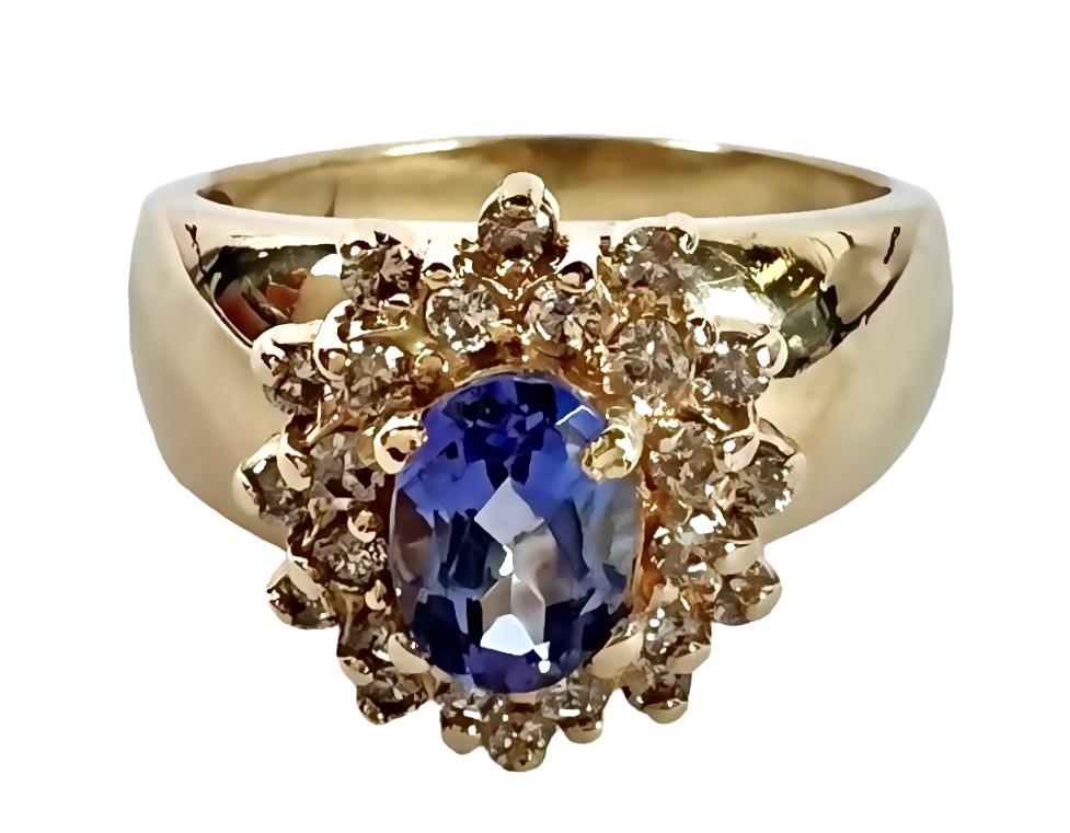 GOLD TANZANITE AND DIAMOND LADIES RING: 14K YELLOW GOLD WITH TANZANITE AND DIAMONDS. OVAL CUT TANZANITE APPROX. .85 CT. 5.8 GRAMS, SIZE 8. APPRAISAL INCLUDED WITH SALE. PLEASE REVIEW APPRAISAL FOR ADDITIONAL DETAILS. ESTIMATED REPLACEMENT V