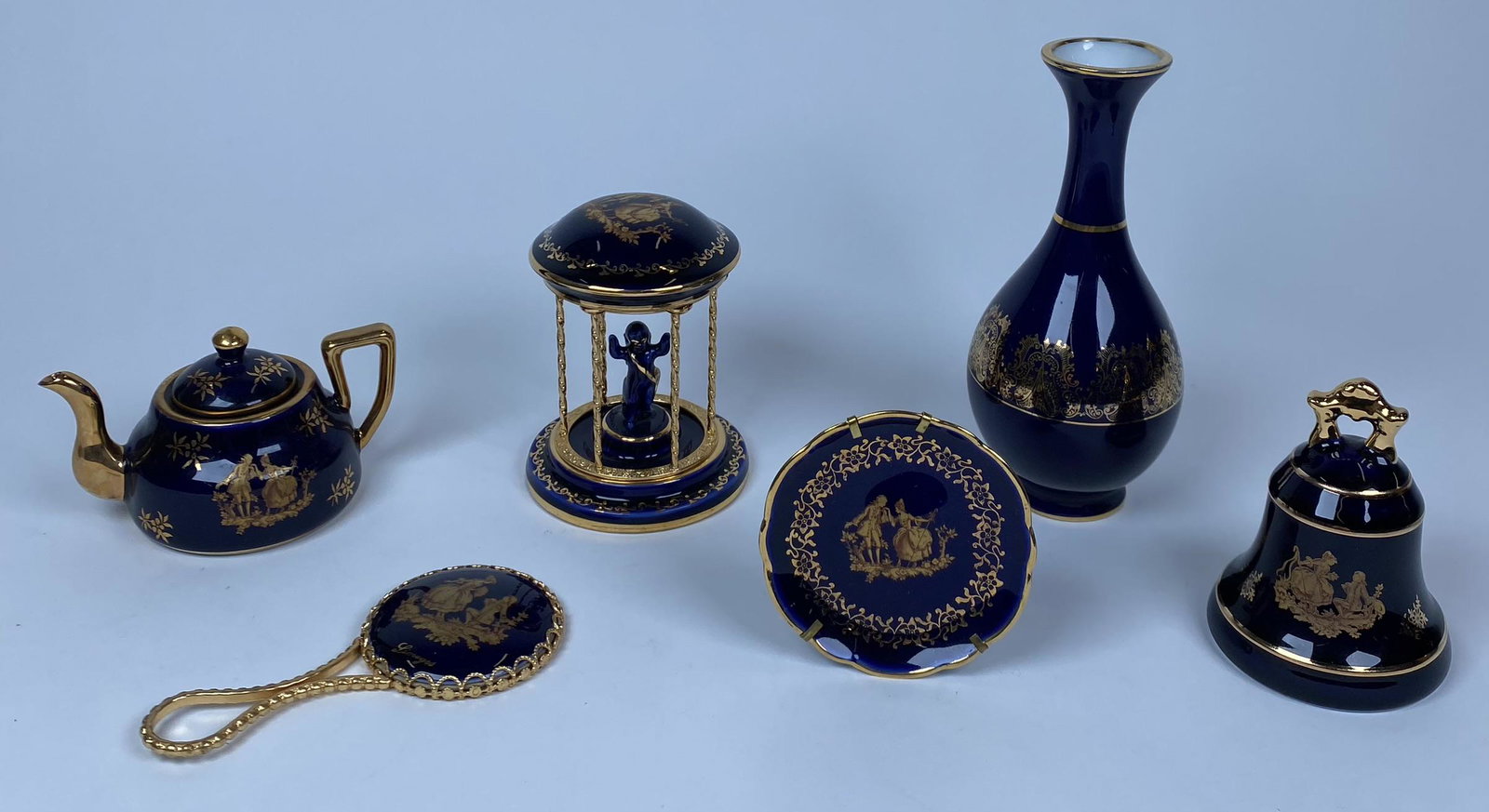 LIMOGE PORCELAIN COLLECTION: COBALT WITH GILT TRIM AND DESIGNS.