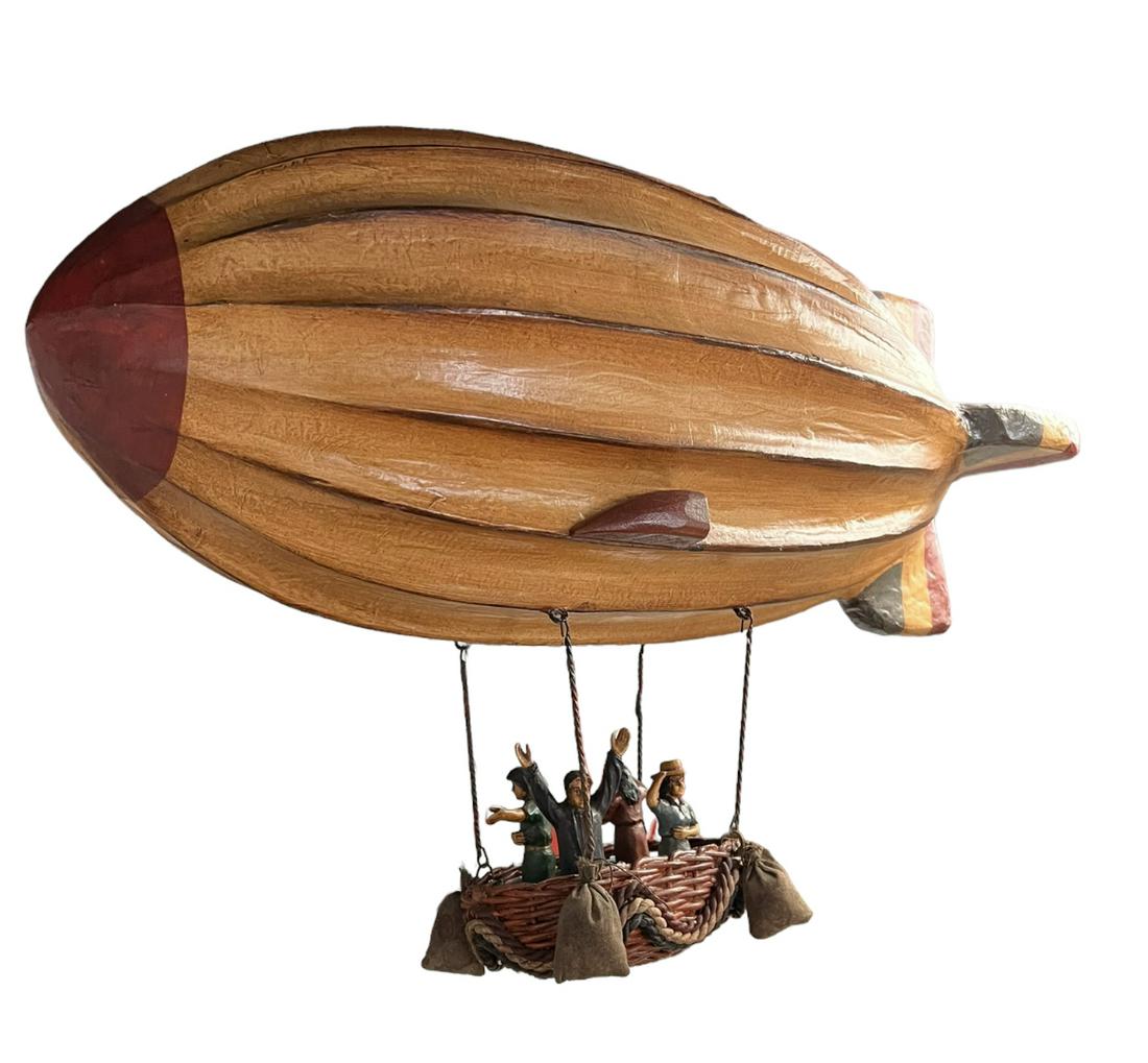 DECORATIVE ZEPPELIN - BLIMP: COMMERCIALLY PRODUCED, PAPER MACHE BLIMP WITH SUSPENDED BASKET OF PASSENGERS. BALLOON IS 28"L