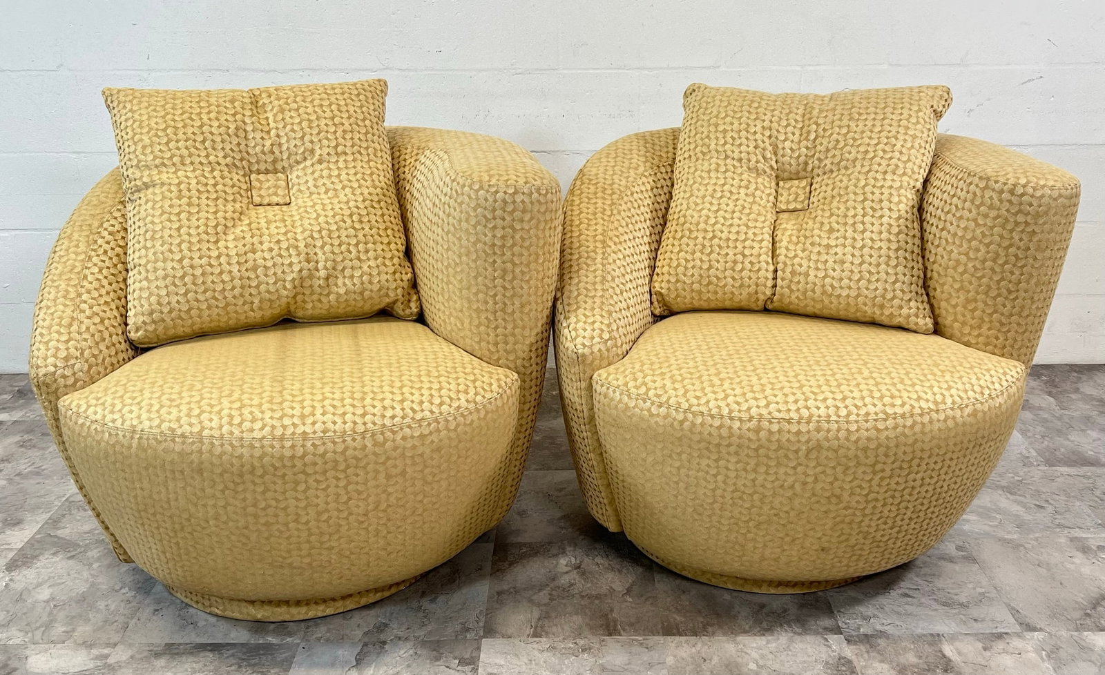 Pair of Nautilus Chairs: In the style of Vladimir Kagan, pair of swivel nautilus chairs. Wear consistent with gentle use.