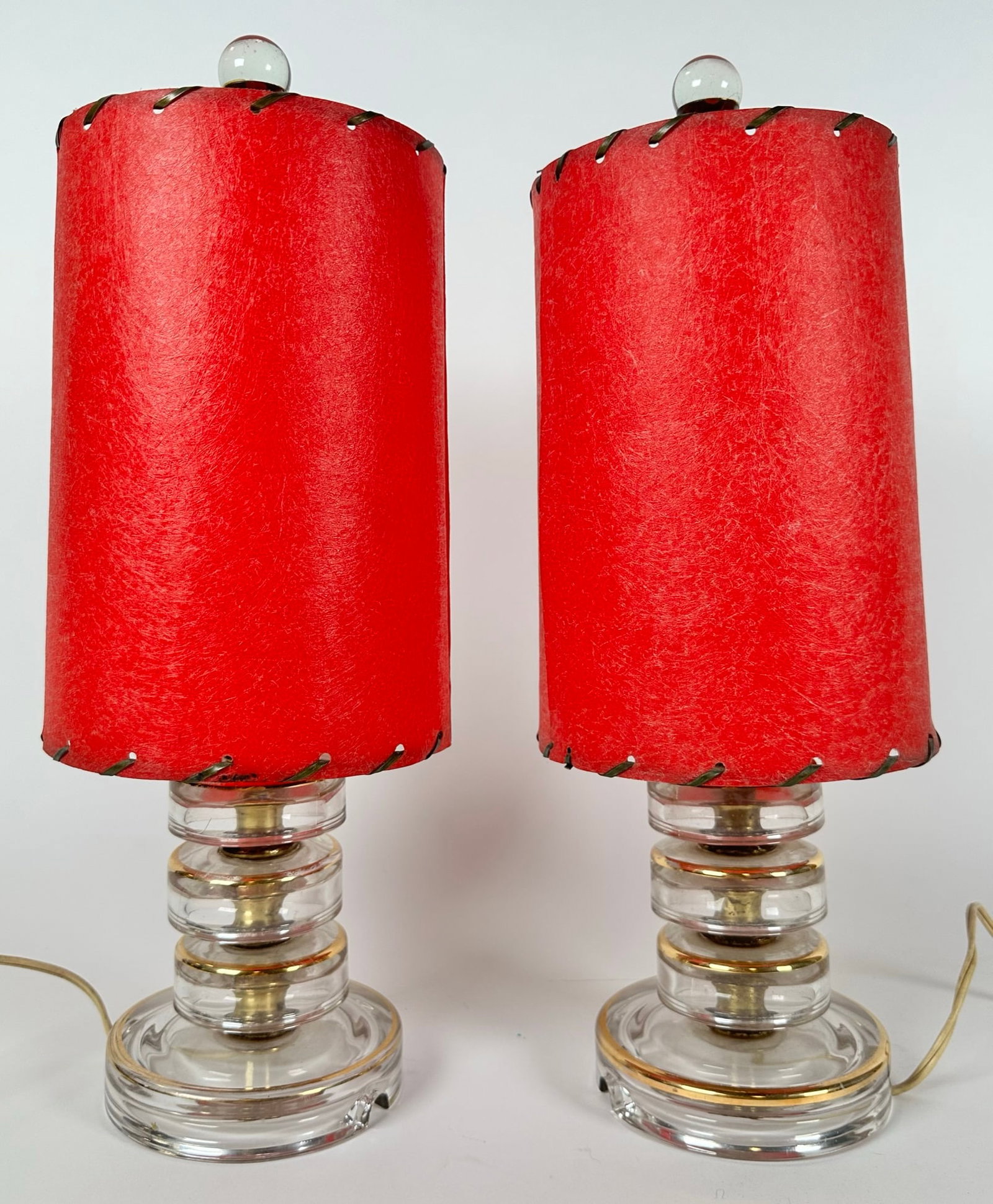 Pair - Diminutive Mid-Century Lamps: Clear glass with gilt circular embellishments, red mica shades. 15"h