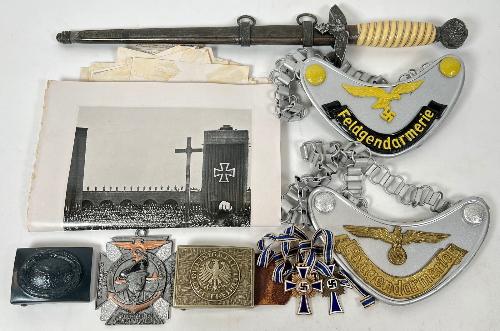 WWII ERA GERMAN MILITARY MEMORABILIA: MILITARIA - WWII GERMAN MILITARY ITEMS INCLUDING GERMAN MOTHER'S CROSSES, BELT BUCKLES, DAGGER, FELDGENDARMERIE GORGET NECK CHAINS, HITLER REGIME INFORMATION PHOTOS. NO MARKING ON THE DAGGER OR SCABBA