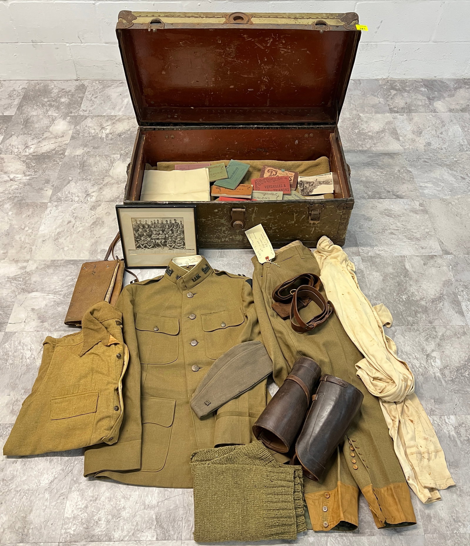 NAMED WWI OFFICER'S FOOTLOCKER WITH CONTENTS: INCLUDES OFFICER'S UNIFORM, EQUIPMENT, STENCILED FOOTLOCKER FROM CAPTAIN T.C. THOGERSON, 14TH LIGHT RAILWAY ENGINEERS. INCLUDES FULL UNIFORM, BLANKET, MAP CASE, PHOTO OF THE SUBJECT IN THE CENTER OF T