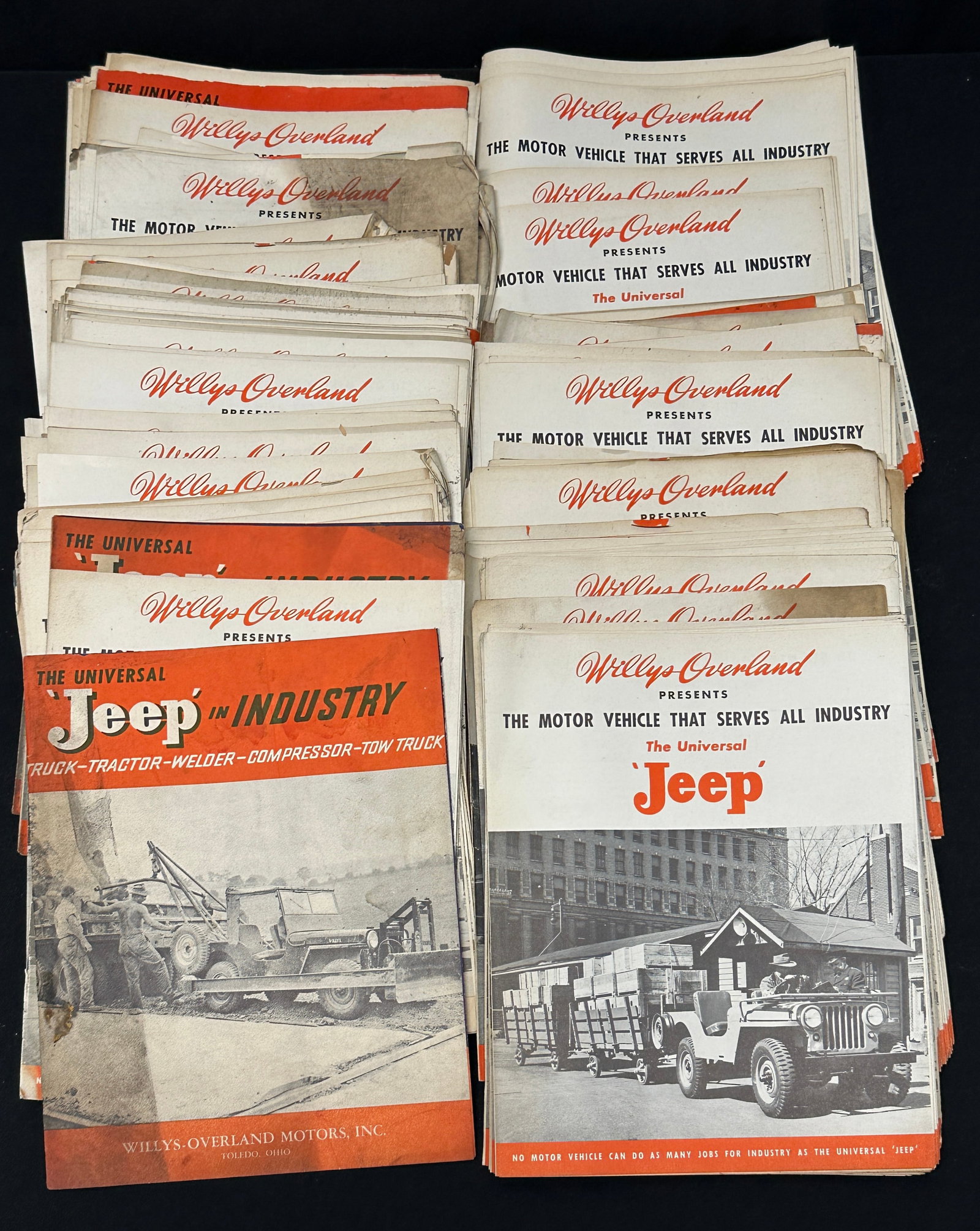 WILLYS OVERLAND JEEP ADVERTISING BROCHURES: APPROXIMATELY 150 ADVERTISNG PIECES PROMOTING JEEP IN INDUSTRY AND THE UNIVERSAL JEEP, C.1940'S. MULTI-FOLD BROCHURES. SHELF WEAR INCLUDING TONING AND CHIPPINNG.